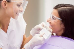 dermatologist female patient discussing digital tablet 107420 65415 طب الأسنان التجميلي